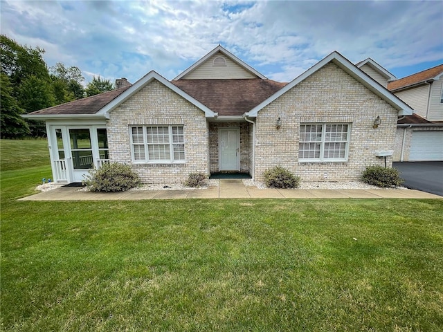 view of front of house with a garage and a front lawn