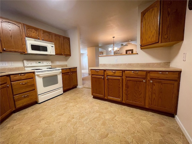 kitchen with a notable chandelier, white appliances, decorative light fixtures, light tile patterned floors, and kitchen peninsula