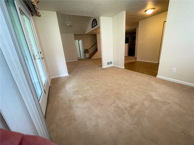 carpeted empty room featuring lofted ceiling and ceiling fan