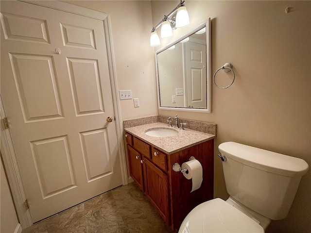 bathroom featuring vanity, toilet, and tile patterned flooring