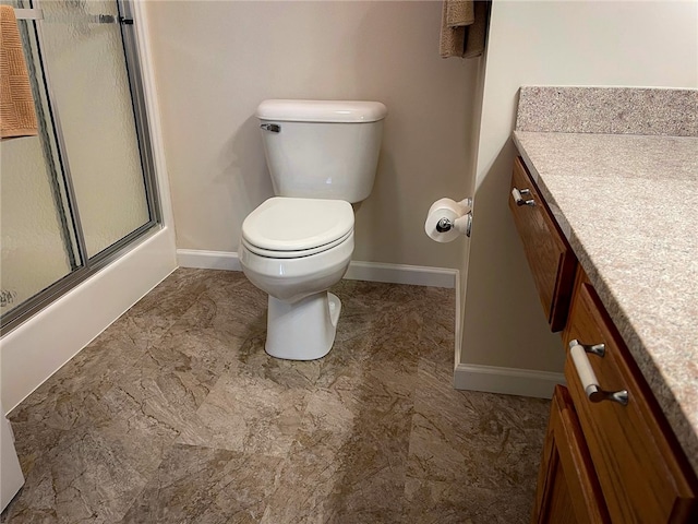 bathroom featuring vanity, toilet, an enclosed shower, and tile patterned flooring