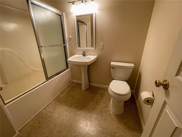 bathroom featuring shower / bath combination with glass door and toilet