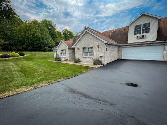 view of front facade with a garage and a front lawn