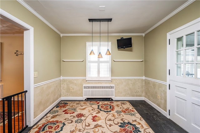 unfurnished dining area featuring radiator, crown molding, a chandelier, and dark hardwood / wood-style floors