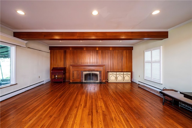 unfurnished living room featuring hardwood / wood-style flooring, ornamental molding, wood walls, and a brick fireplace