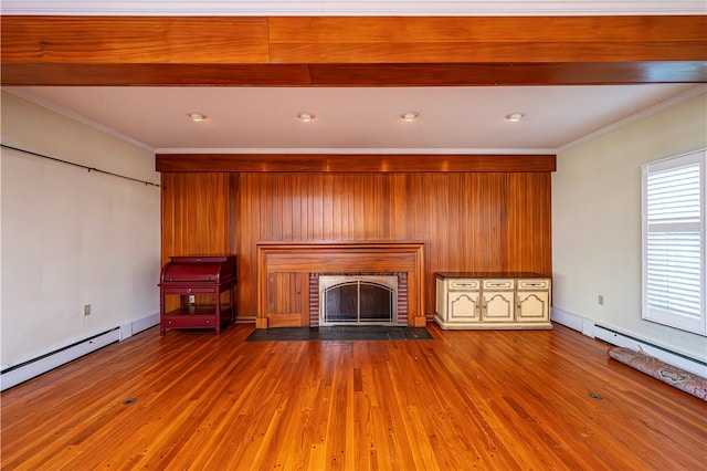 unfurnished living room with beam ceiling, a fireplace, ornamental molding, and hardwood / wood-style floors