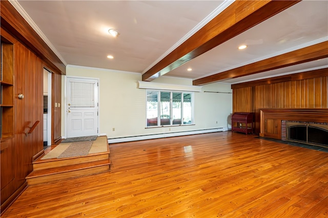 living room featuring wood walls, beam ceiling, light hardwood / wood-style flooring, ornamental molding, and a baseboard heating unit