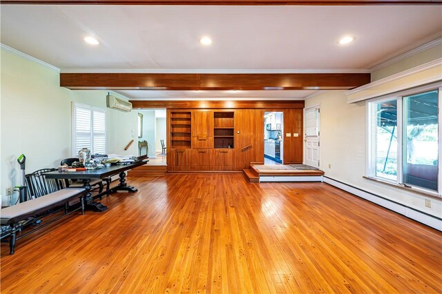 living room featuring light wood-type flooring, ornamental molding, a wall unit AC, and a baseboard radiator