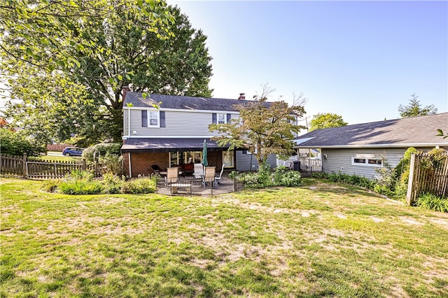 back of property featuring a yard and a patio area