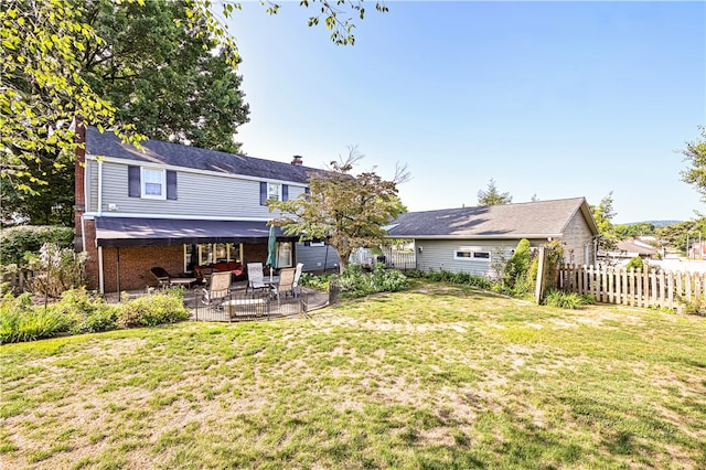 back of house featuring a yard and a patio