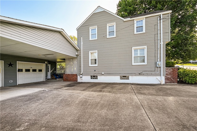 view of property exterior featuring a garage and a carport