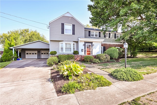 view of front of home with an outbuilding, a garage, and a front lawn