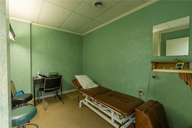 carpeted office space with a paneled ceiling