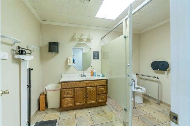 bathroom featuring vanity, tile patterned flooring, crown molding, toilet, and a shower