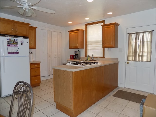 kitchen with white appliances, light tile patterned floors, and ceiling fan