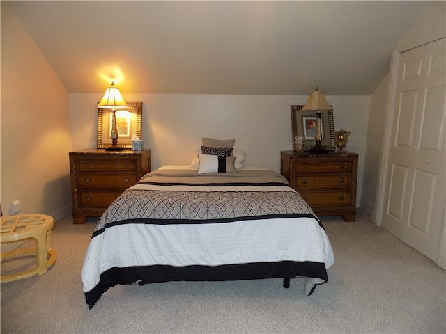 carpeted bedroom with lofted ceiling