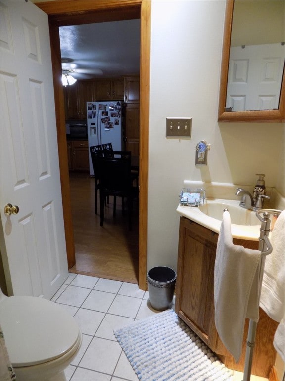 bathroom featuring vanity, toilet, ceiling fan, and tile patterned flooring