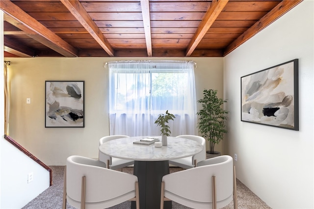 dining space with beam ceiling, carpet floors, and wooden ceiling