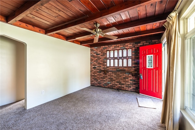 spare room featuring wood ceiling, brick wall, ceiling fan, and carpet