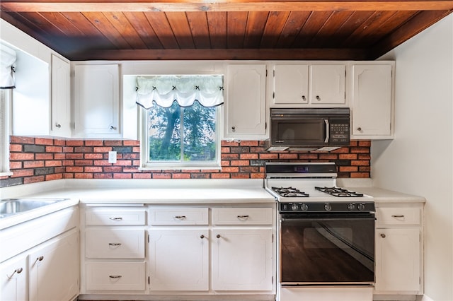 kitchen featuring wooden ceiling, white cabinetry, and white range with gas stovetop