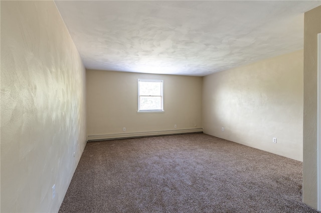 carpeted spare room with baseboard heating