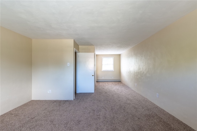 carpeted spare room with baseboard heating