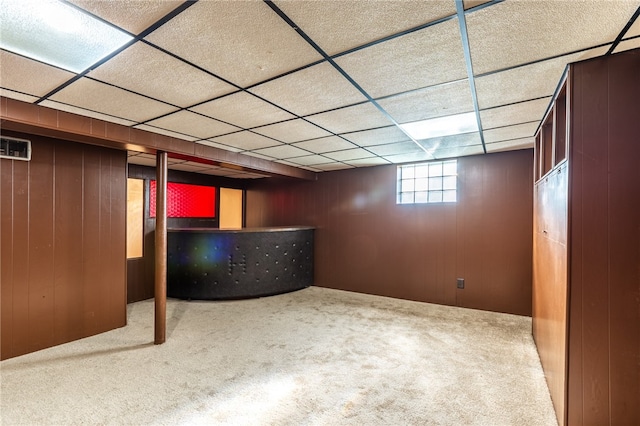 basement with a drop ceiling and carpet floors