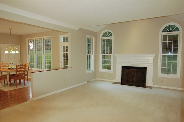 living room featuring a chandelier, carpet floors, and crown molding