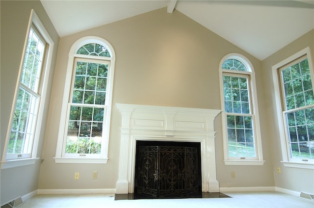 unfurnished living room with lofted ceiling with beams and plenty of natural light