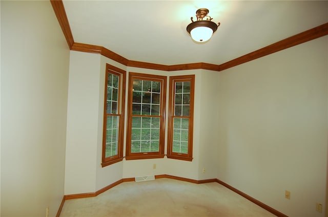 unfurnished room featuring ornamental molding and carpet