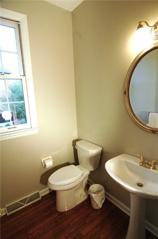 bathroom featuring wood-type flooring and toilet