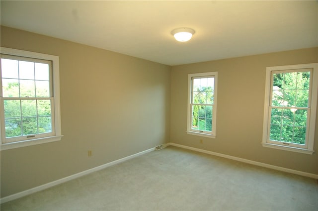 carpeted empty room with plenty of natural light