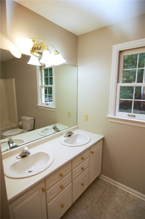 bathroom featuring vanity, toilet, and tile patterned floors