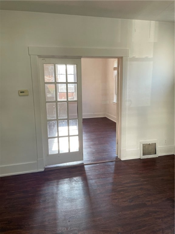 empty room with dark hardwood / wood-style floors