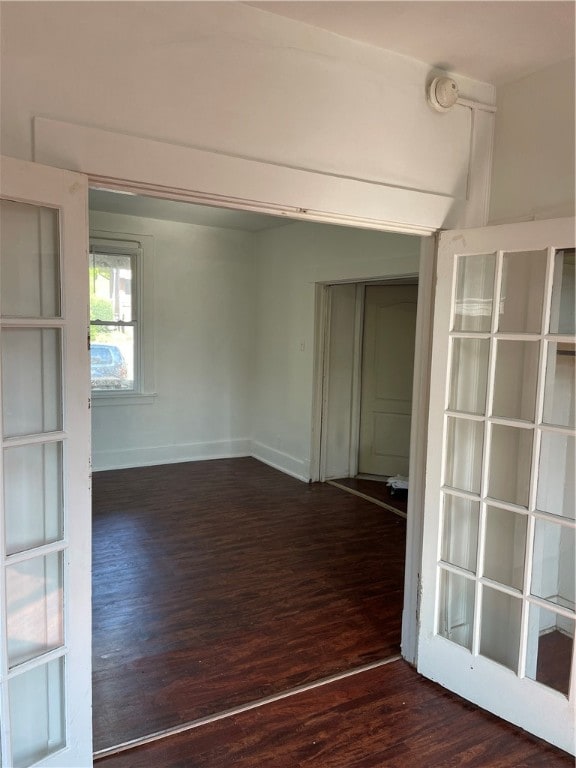 unfurnished room with dark wood-type flooring