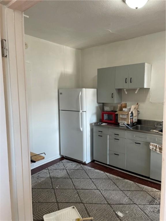 623 Beaver St, Ambridge, PA 15003 - kitchen with freestanding refrigerator, stainless steel countertops, and a sink