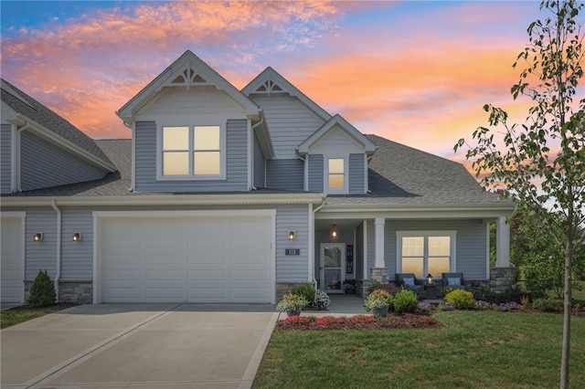 craftsman inspired home with a yard and a garage