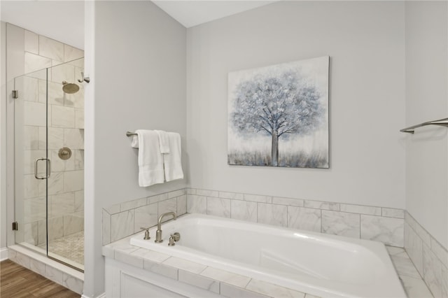 bathroom with wood-type flooring and separate shower and tub