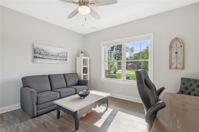 living room featuring dark wood-type flooring and ceiling fan