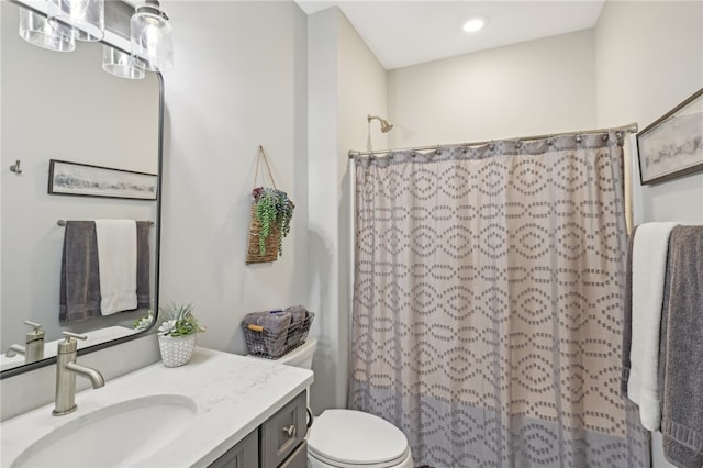 bathroom with vanity, toilet, and walk in shower