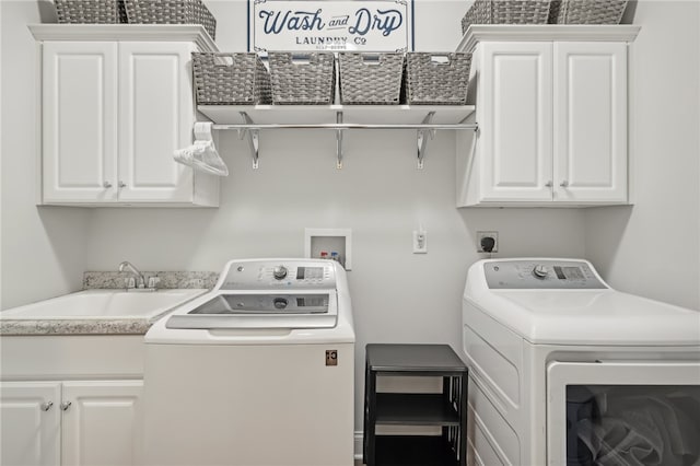 laundry area with washer and dryer, cabinets, and sink