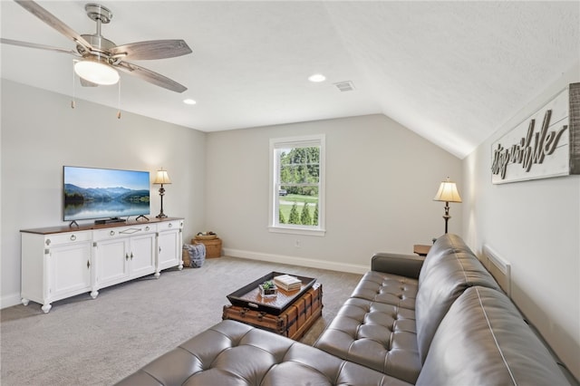 living room featuring lofted ceiling, ceiling fan, and carpet