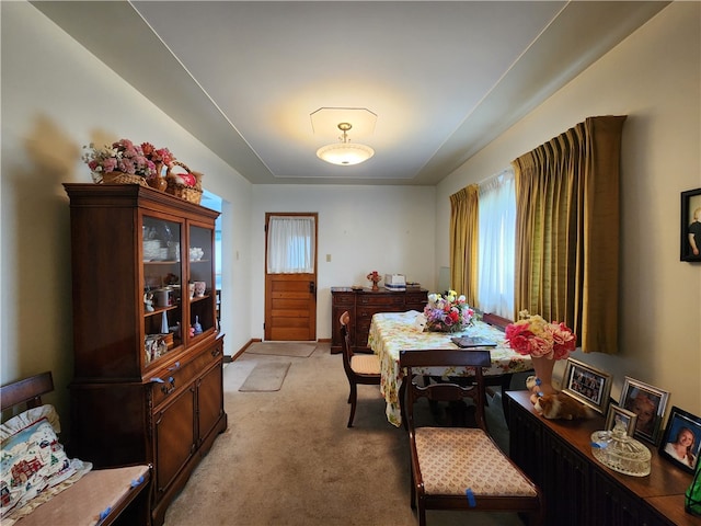 dining area featuring light carpet