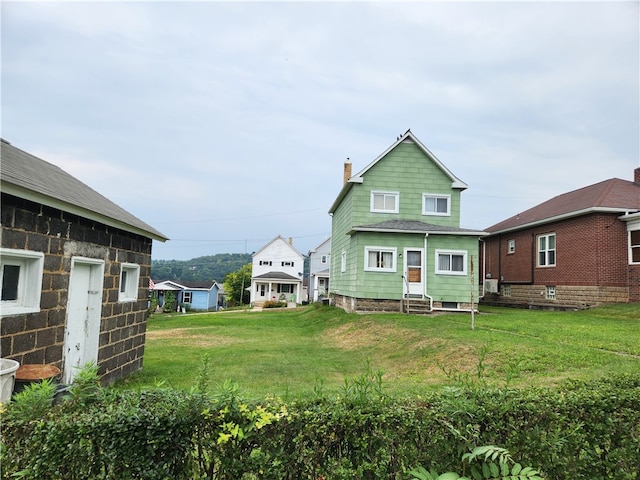 rear view of property with a lawn