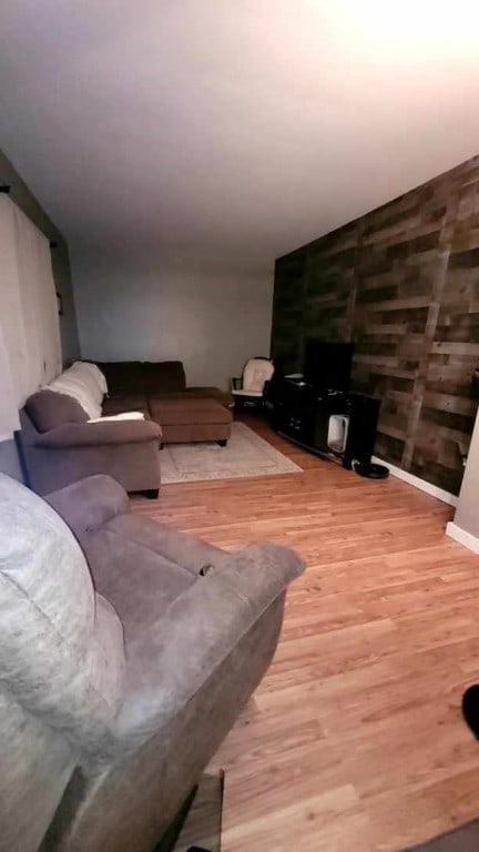 living room with hardwood / wood-style flooring and vaulted ceiling