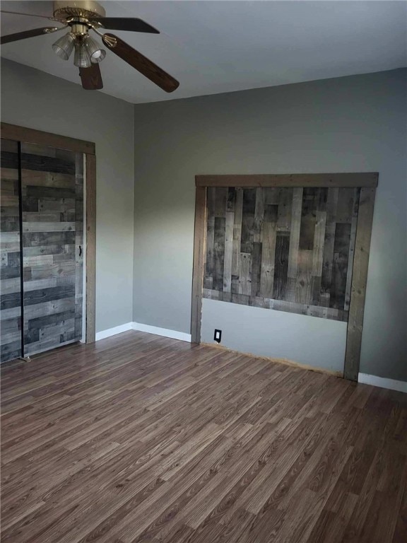 spare room with ceiling fan and dark hardwood / wood-style floors