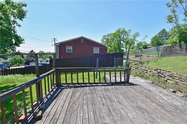 wooden terrace featuring a yard