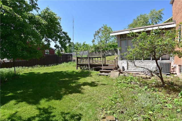 view of yard with central AC unit and a deck