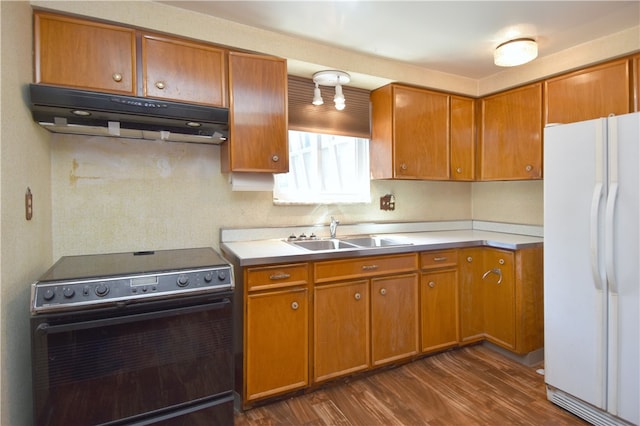 kitchen with range with electric stovetop, sink, white refrigerator, and dark hardwood / wood-style flooring