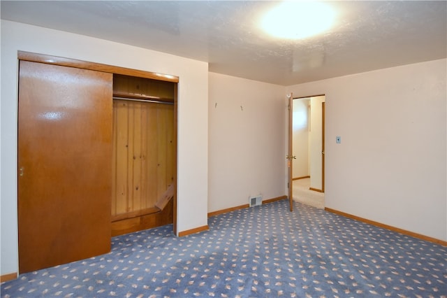 unfurnished bedroom featuring a closet and carpet floors